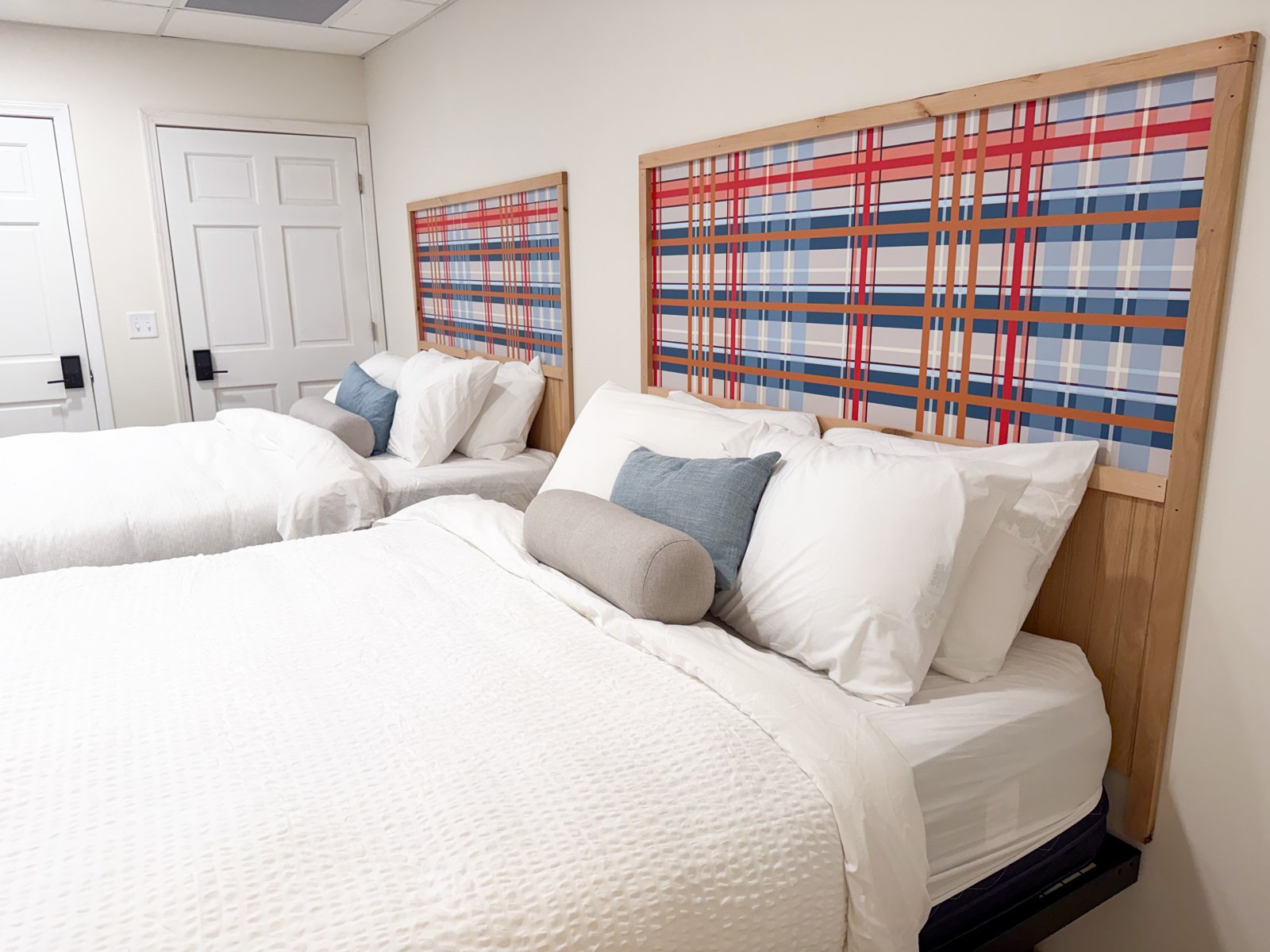 Spacious Studio Suite at Explorer Rest & Recreation with two queen beds and signature plaid headboards